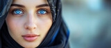 Portrait of a Arab woman in hijab with blue eyes. Traditional clothing. Banner