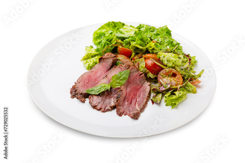 Salad with roast beef in a white plate. Isolated.
