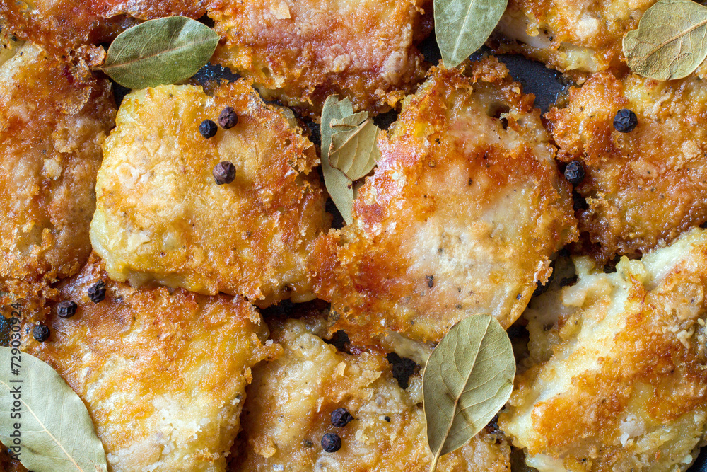 Fried fish fillet. Pieces of fried sea bass fillet. Close-up. Top view. Fried fish fillet. Pieces of fried sea bass fillet. Close-up. Top view.