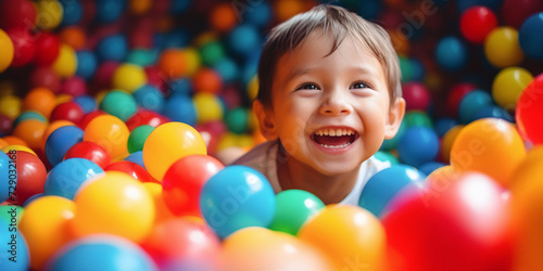 Joyful child in colorful ball pit play area, perfect for family fun centers, indoor playgrounds, and birthday party venues. AI Generative