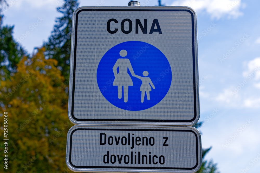 Scenic view of traffic sign for pedestrian zone with text allowed with permission at lakeshore of Lake Bled on a cloudy summer day. Photo taken August 8th, 2023, Bled, Slovenia. Scenic view of traffic sign for pedestrian zone with text allowed with permission at lakeshore of Lake Bled on a cloudy summer day. Photo taken August 8th, 2023, Bled, Slovenia.