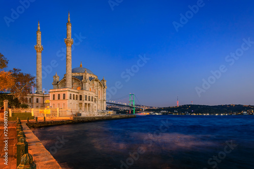 Picturesque cityscape with the Bosphorus Strait and the Grand Mecidiye Mosque Ortakoy Mosque and the Bosphorus Bridge Istanbul, Turkey at sunset
