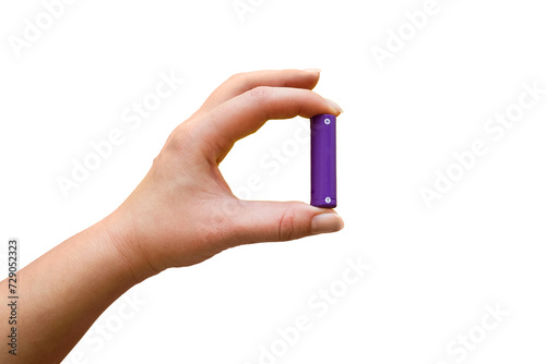 Hand holds AA battery on transparent background