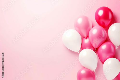 Pastel pink table with frame from balloons and confetti for birthday top view. Flat lay composition.