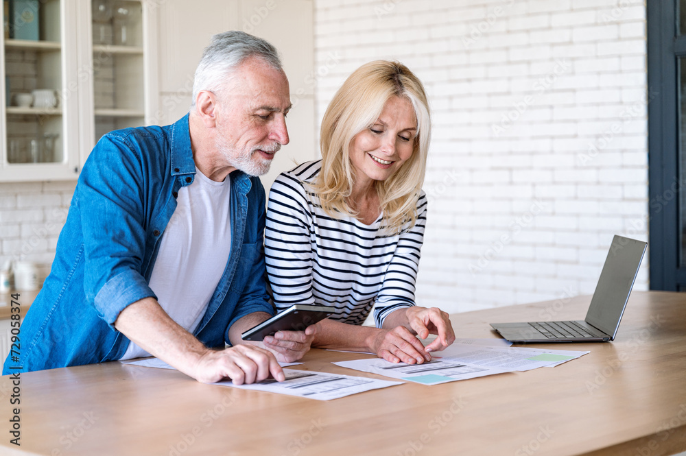 Husband and wife check taxes, paying utility bills Husband and wife check taxes, paying utility bills