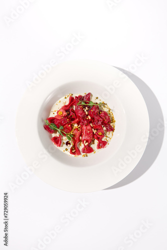 Top View of Beetroot Ravioli Bows in Cream Sauce, Beautifully Served for Gourmet Italian Dining Experiences