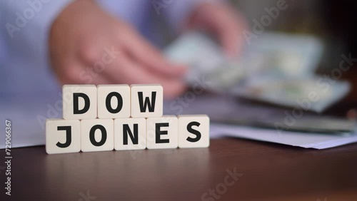Concept of investing in the Dow Jones Stock Market. Selective focus with person counting money on the background. photo