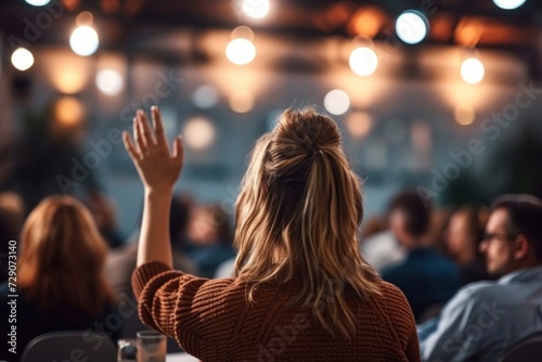 Rear view of a casual businesswoman raising her arm in a conference meeting, symbolizing engagement and proactive participation, Generative AI