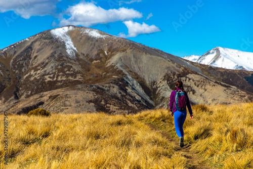 adventurous hiker girl on the way to the top of trig m, scenic peak in new zealand alps, near arthur's pass village and lake lyndon   © Jakub