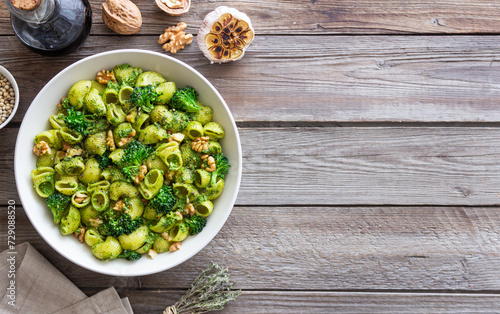 Pasta with broccoli, pesto sauce and nuts. Italian cuisine. Healthy eating.