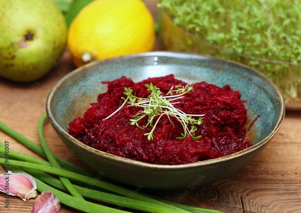 Traditional spicy beetroot salad with garlic and lemon juice. Bowl with beetroot salad decorated with garden cress. Traditional spicy beetroot salad with garlic and lemon juice. Bowl with beetroot salad decorated with garden cress.