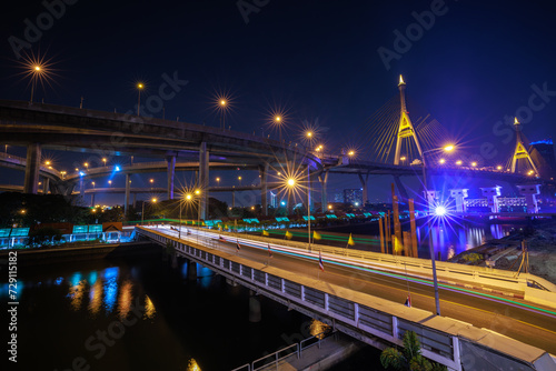 Night scene shot and over starlight effect, Bhumibol bridge and reflection of water. bangkok thailand, wide angle cityscape at night