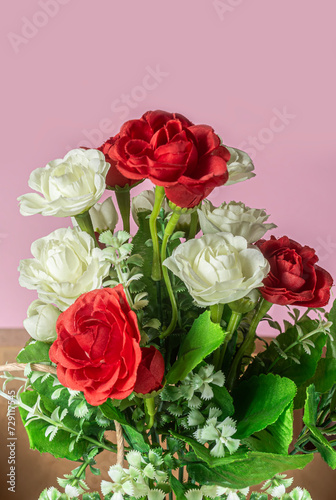 bouquet of red  white and pink roses on pink background. Closeup