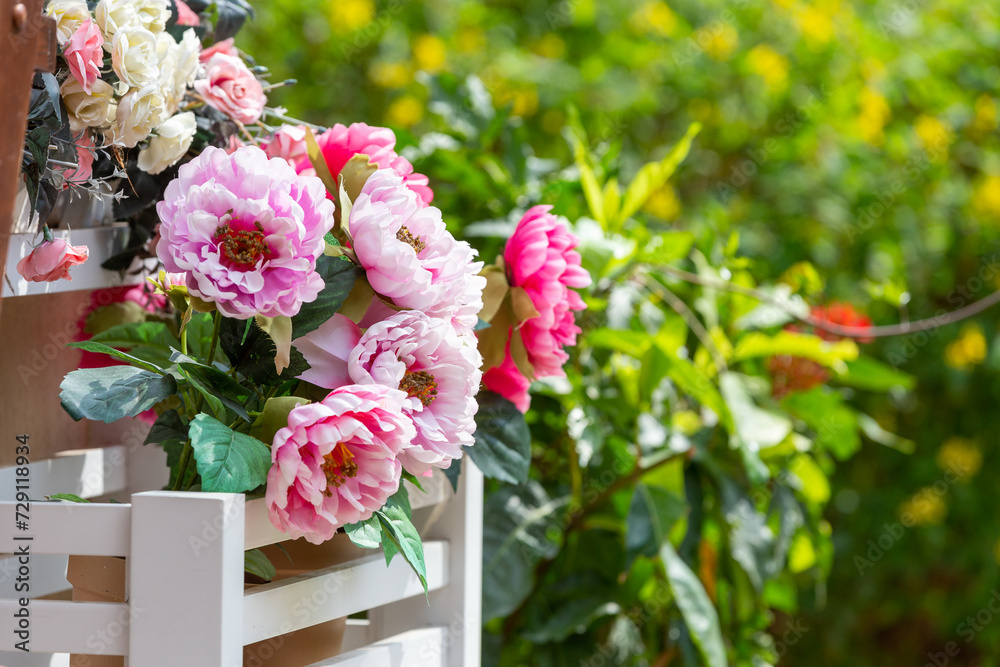 A beautiful bouquet of flowers in a garden, bursting with vibrant colors like pink, red, purple, and white, showcasing the natural beauty of spring and summer