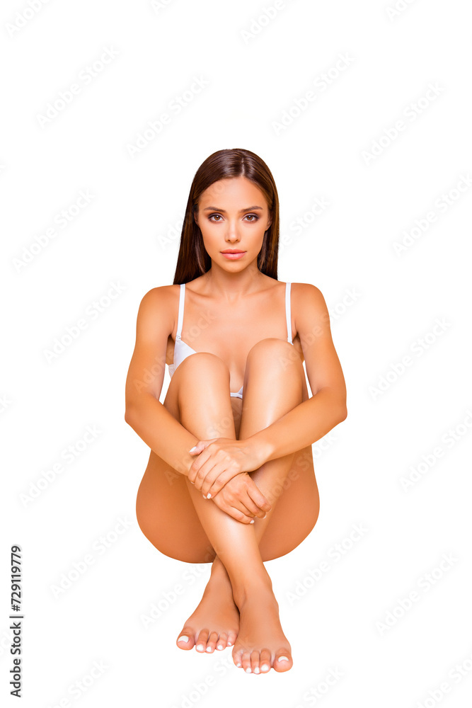 Obraz premium Full legs body size vertical portrait of attractive careless carefree lady she sit on the floor isolated on pastel beige background with her perfect ideal slim fit figure hug herself self