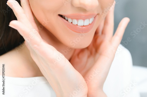 Beautiful Smile With White Teeth. Closeup Of Smiling Woman Mouth With Natural Plump Full Lips And Healthy Perfect Smile photo