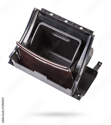 An opened ashtray from panel of car interior separately on a white isolated background with wooden decorative overlay.