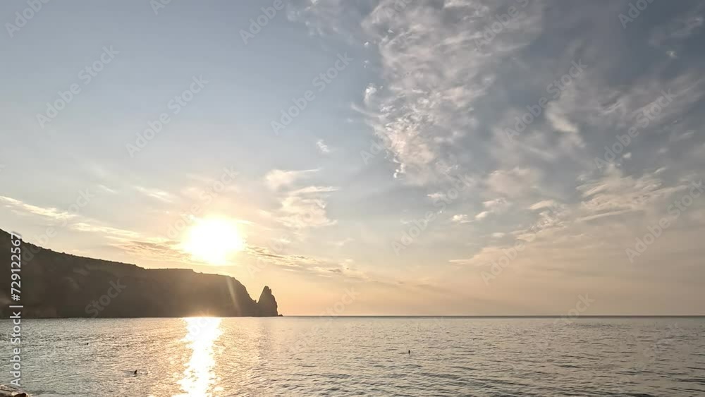 Timelapse fluffy Cumulus clouds moving in bright golden sunset sky over sea. Abstract aerial nature summer ocean sunset, sea and sky view. Vacation, travel, holiday concept. Weather and Climate Change