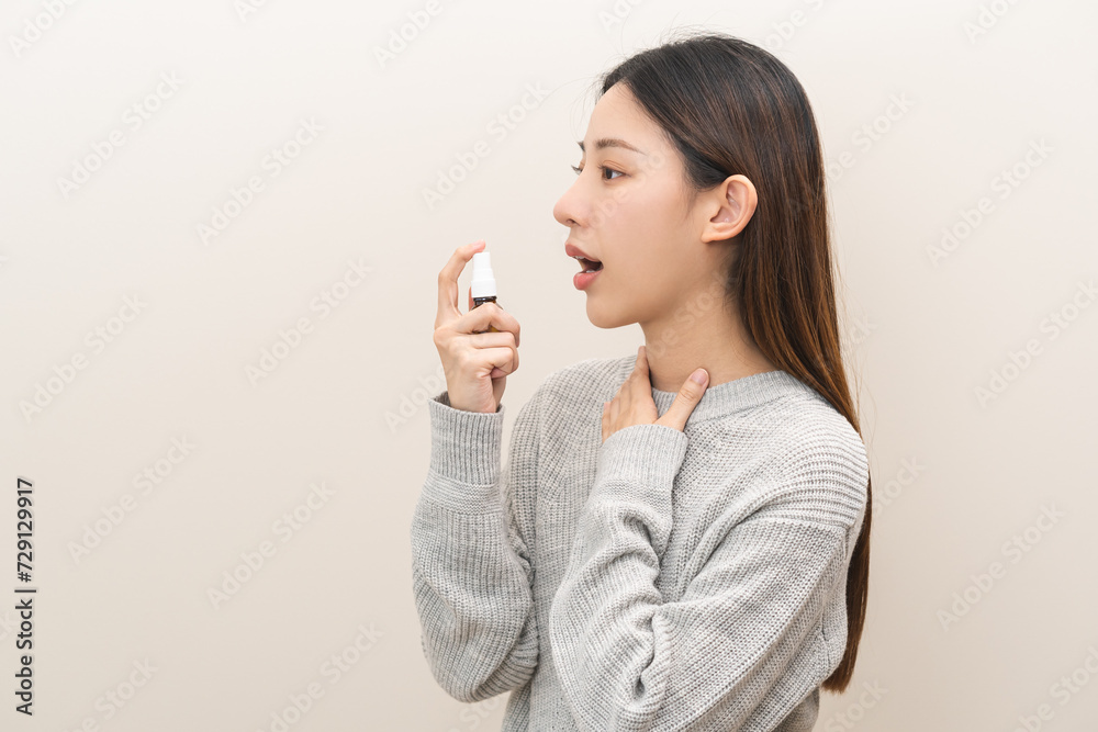 Health care treatment sore throat concept, sick pain asian young woman have cough symptom holding medicine bottle, using spray in mouth to protect disease from bacteria, illness from virus infection. Health care treatment sore throat concept, sick pain asian young woman have cough symptom holding medicine bottle, using spray in mouth to protect disease from bacteria, illness from virus infection.