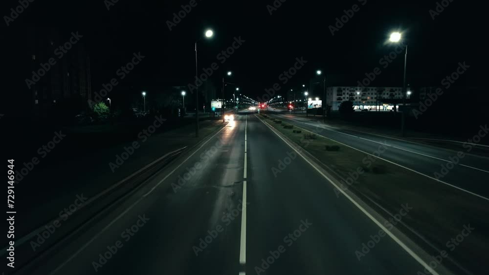 Belarus, Minsk - July 25, 2023: Aerial view of night intersection with traffic light and car with flashing headlights Belarus, Minsk - July 25, 2023: Aerial view of night intersection with traffic light and car with flashing headlights