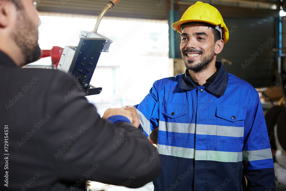 worker or engineer fist bump with businessman for agreement or success at works in the factory worker or engineer fist bump with businessman for agreement or success at works in the factory