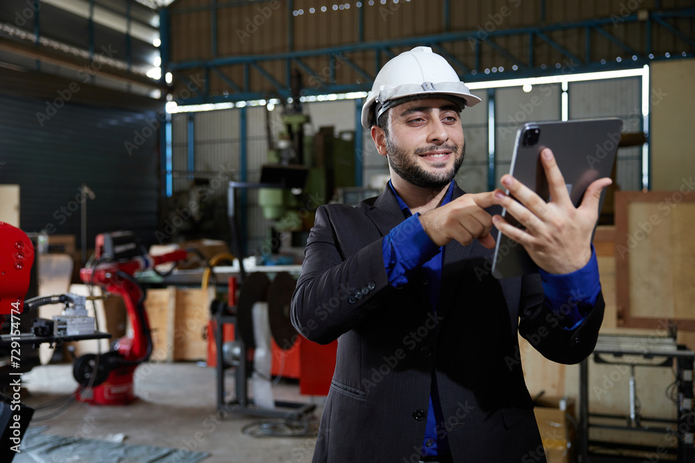 businessman using tablet for video call online and talking to someone in robot factory businessman using tablet for video call online and talking to someone in robot factory