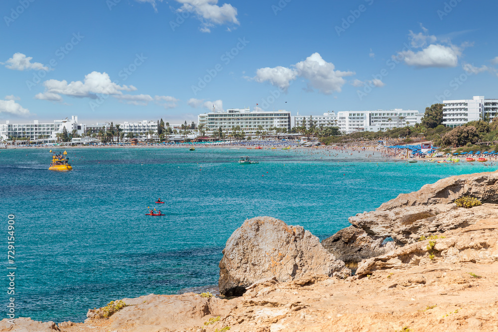 Vacation resort of Ayia Napa. A paradise for vacationers. A sunny day with a blue sky and white clouds. Panoramic view of the hotels and Nissi beach.