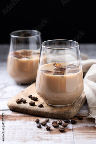 Traditional Irish cream coffee liqueur with ice on wooden table