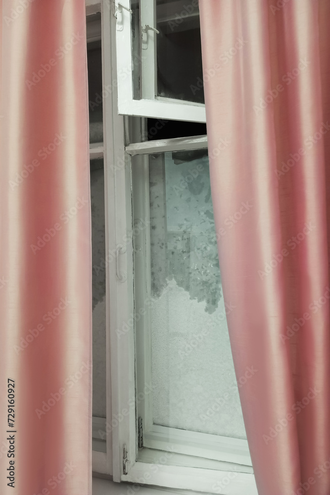 Fototapeta premium An old wooden window covered with ice and frost.