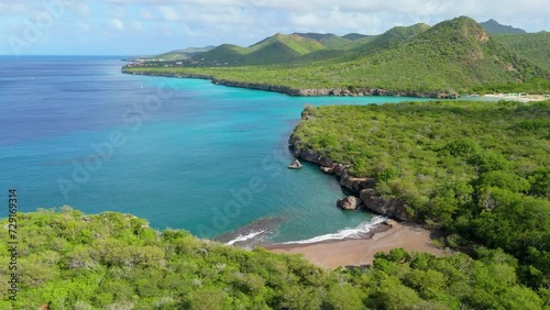 Drone obit around playa Santu Pretu tropical getaway with Christoffelberg and Westpunt in distance photo