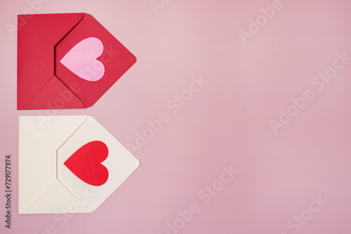 Red and White Envelopes with red and pink heart for valentine day on pink background Copy space horizontal