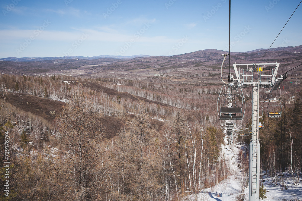 Sunny Winter Day at Mountain Top with Ski Lift and Snow-Covered Trees