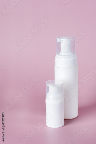 White cosmetic bottle mockup on pink background. Minimalist product still life Beauty blogging Cosmetic background Hygiene  skin and body care. Copy ad space Vertical