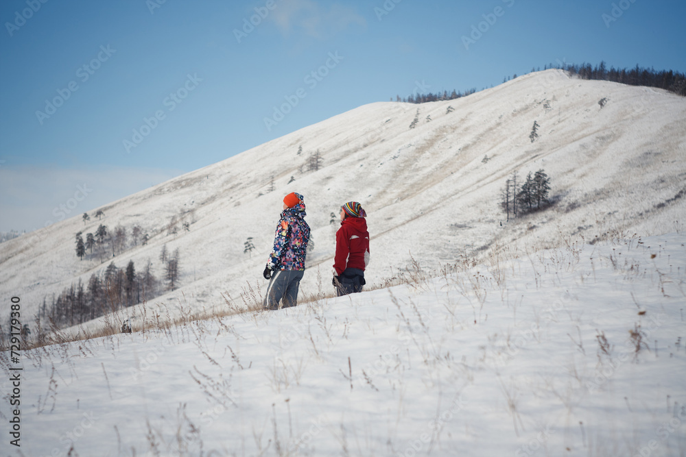 Adventurous Couple Standing on Snowy Hill, Enjoying Spectacular Scenic View of Winter Landscape
