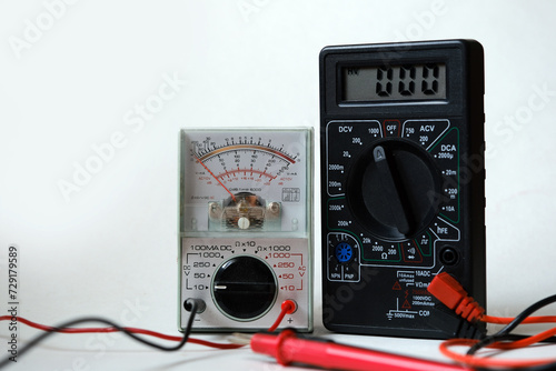 Digital and analog devices in the same frame. Two different types of multimeters. Electrical - electronic test and measurement devices. photo