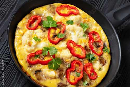 omelette with vegetables in a pan, top view