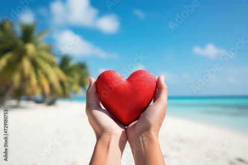 Red heart in womans hands at the beach and sea background.Travel and Honeymoon Promotions concept Wellness and Relaxation Campaigns concept Relationship and Dating Apps concept.