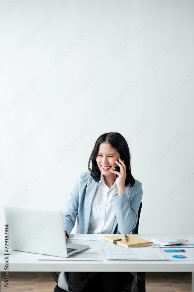 Portrait of smile beautiful business asian woman in blue suit working office desk computer. Small business sme . Portrait of smile beautiful business asian woman in blue suit working office desk computer. Small business sme .
