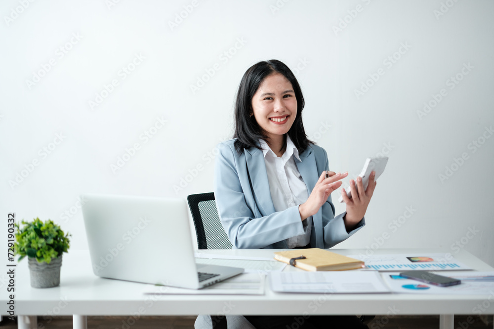 Portrait of smile beautiful business asian woman in blue suit working office desk computer. Small business sme . Portrait of smile beautiful business asian woman in blue suit working office desk computer. Small business sme .