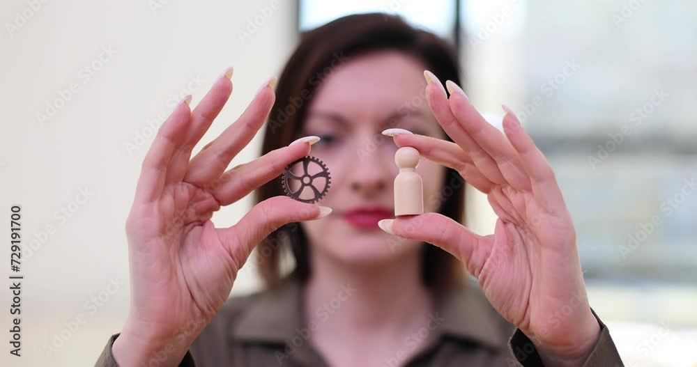 Metal gears and white wooden figure closeup