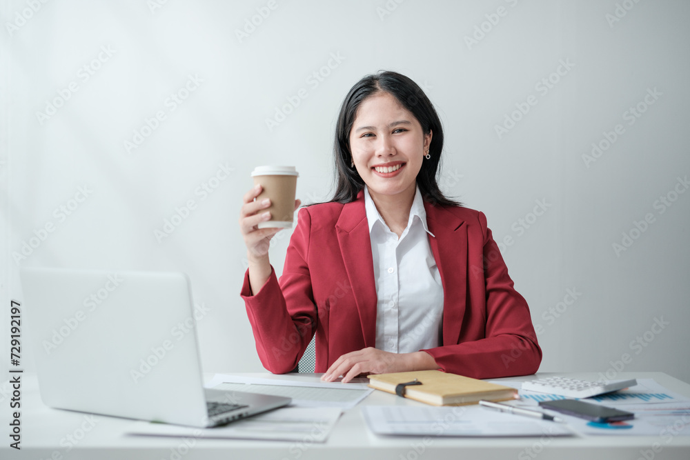 Portrait of smile beautiful business asian woman in red suit working office desk computer. Small business sme . Portrait of smile beautiful business asian woman in red suit working office desk computer. Small business sme .