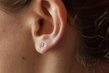 earlobe with a freshly inserted stud earring