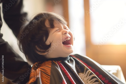 child laughing, hairdresser cape draped around them
