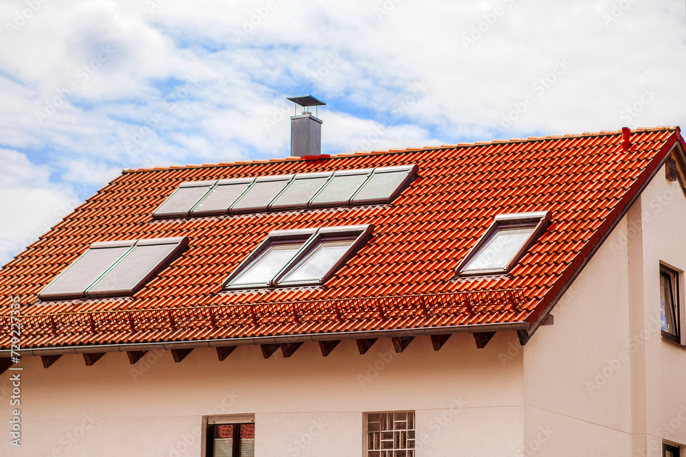 Skylights Roof Windows Dormers with Shutters Outdoor on Red Tiles Roof of Private House on Sky Background.