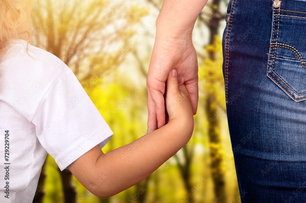 Child holding mother hand. Happy family Child holding mother hand. Happy family