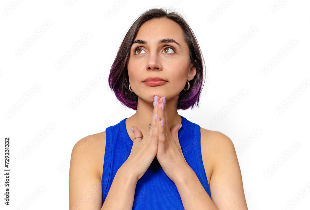 Naklejka premium Portrait of a dreamy woman, hands under chin. Looks up. Blue dress. White background, isolated.