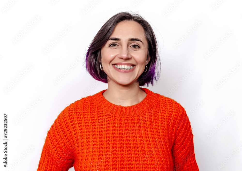 Bright smile of attractive cheerful dark-haired woman. Orange knitted warm sweater. Bright smile of attractive cheerful dark-haired woman. Orange knitted warm sweater.