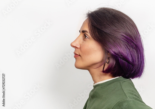Blackhaired model with short shiny purple hairdo. Hair coloring concept. Copy space.