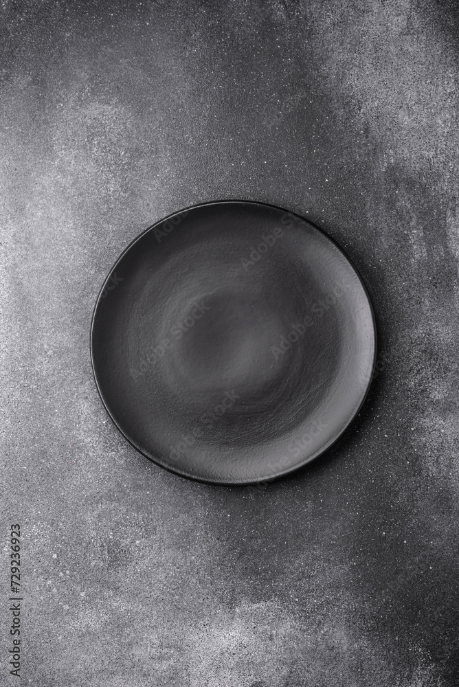 Empty round ceramic plate on a light texture background Empty round ceramic plate on a light texture background