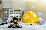 Labor and Construction law concept. judge gavel on building blueprint plans with a yellow safety helmet and building model with law icons. Quality assurance, Guarantee, Standards, ISO certification.